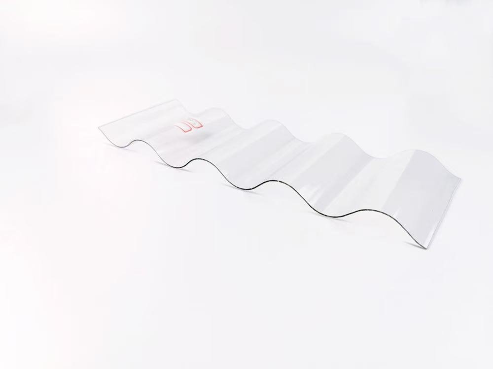 04b9fee5da6ec7a8604491c290244149 - Transparent corrugated plastic sheet with alternating folds on a white surface, viewed from above.