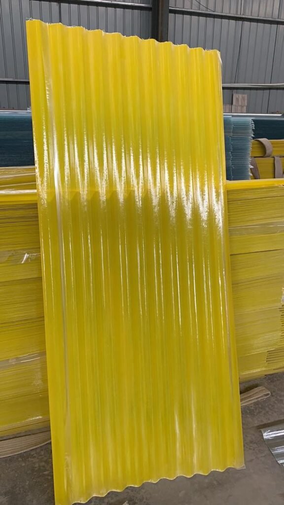 微信图片_20260413135214_350_159 - Bright yellow corrugated plastic sheets standing upright in a warehouse, ready for use as panels or roofing.