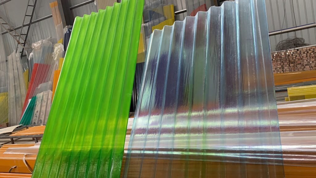 Green and clear corrugated plastic sheets leaning in a warehouse aisle.