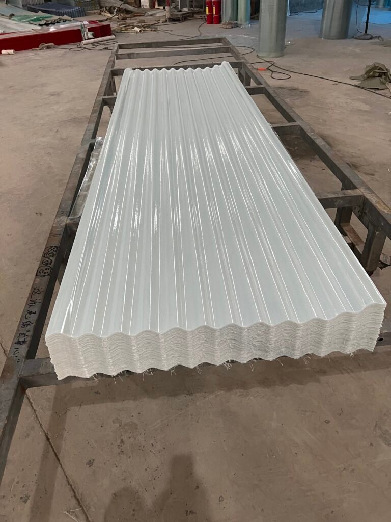 微信图片_20260216232946_194_14 - Stack of white corrugated metal sheets on a metal worktable in a workshop.